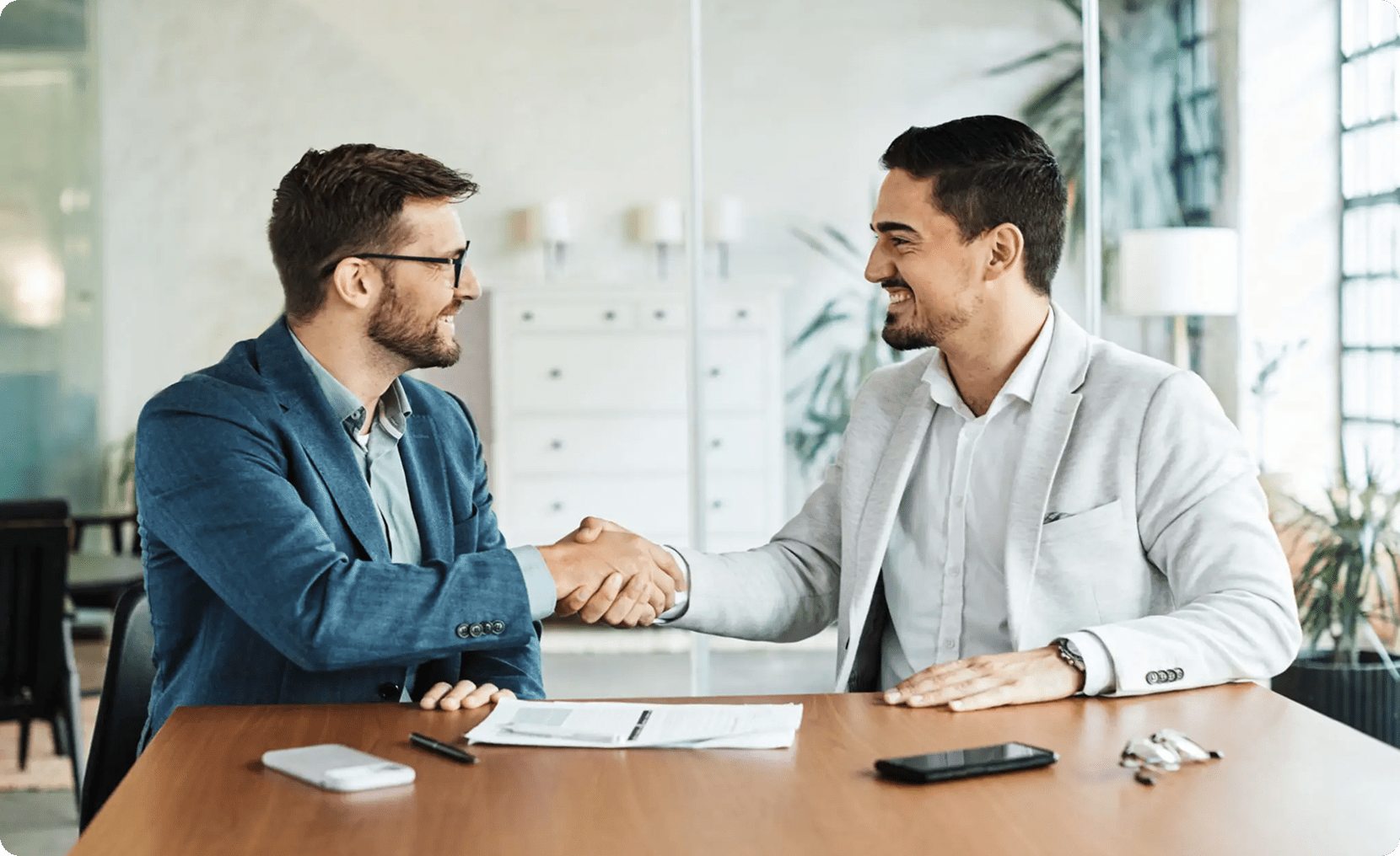 Two men in suits shaking hands